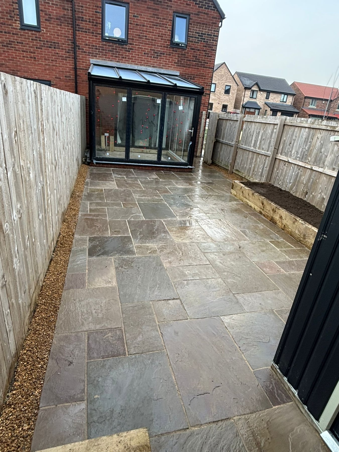 Patio paving with gravel edging and new fencing by Ashurst and Sons Roofing