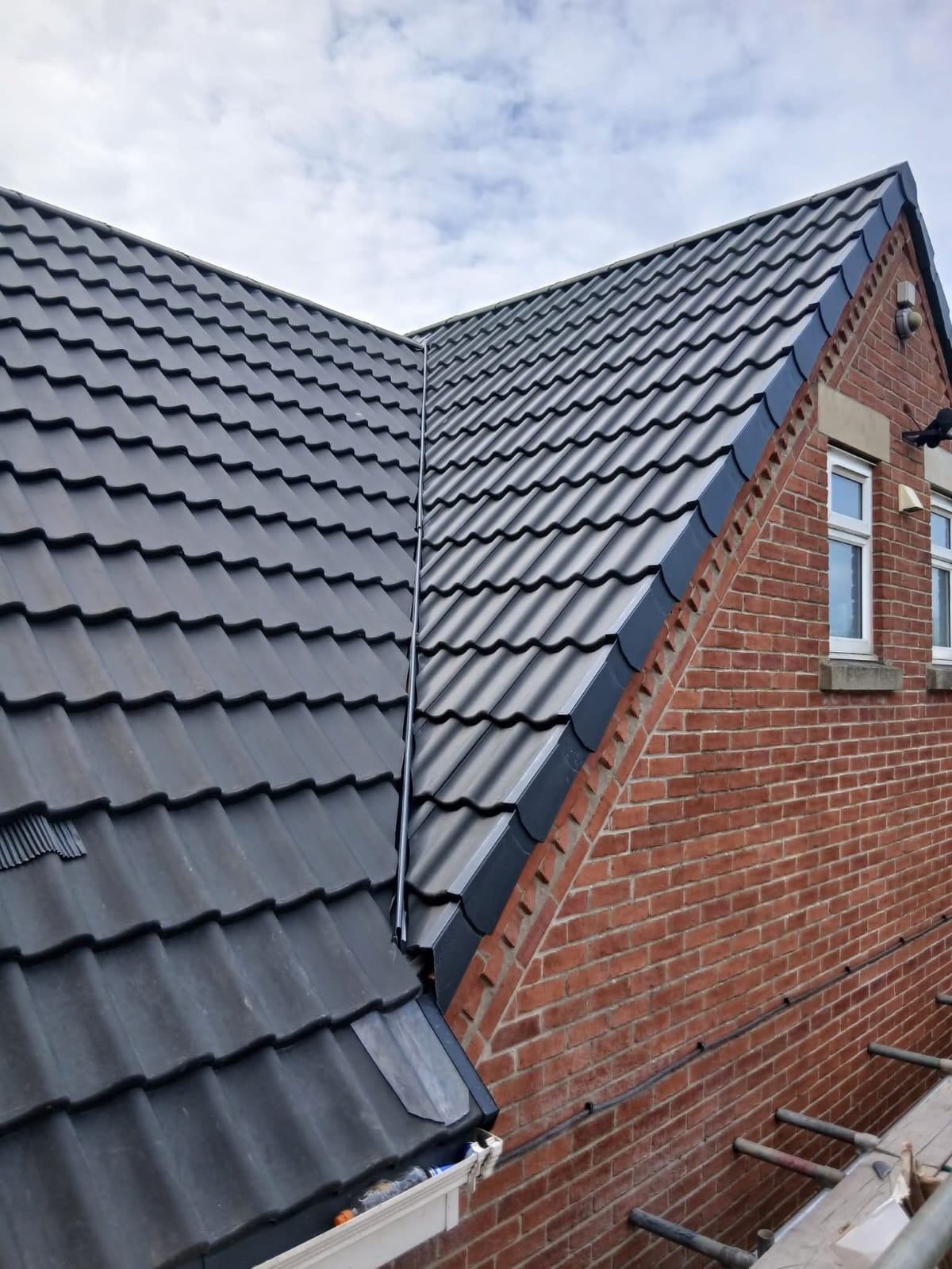 Grey tiled roof valley finished by Ashurst and Sons Roofing